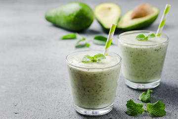 Healthy avocado spinach green smoothie. Selective focus, close up, copy space. 