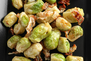 Brussels sprouts with bacon on plate, closeup