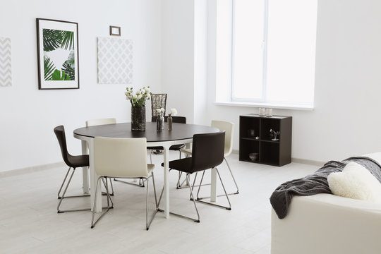Modern room interior with big table and chairs
