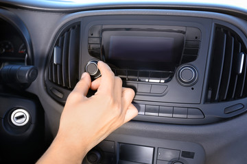 Man tuning car radio, closeup