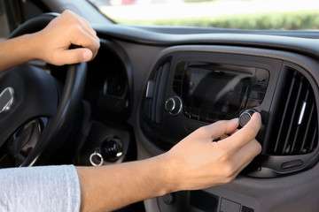 Man tuning car radio, closeup