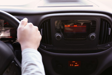 Man driving car while listening to radio