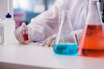 Chemist working in the laboratory with hazardous chemicals