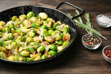 Dish with roasted brussel sprouts on table