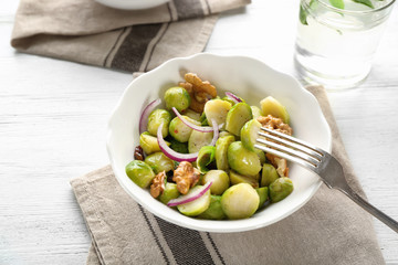 Bowl with brussel sprout salad on table