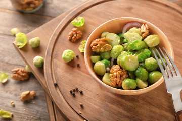 Bowl with brussel sprout salad on wooden boards