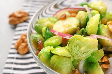 Bowl with brussel sprout salad on table, closeup