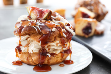 Delicious cake with caramel sauce on plate
