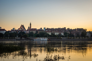 Fototapeta na wymiar Dusk over the old town and Vistula river in Warsaw, Poland