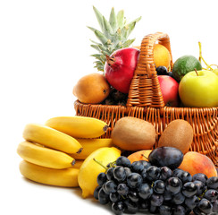 Fresh fruits and basket on white background