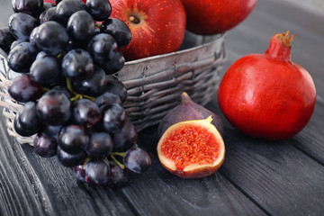 Naklejka na ściany i meble Basket and fresh fruits on wooden table