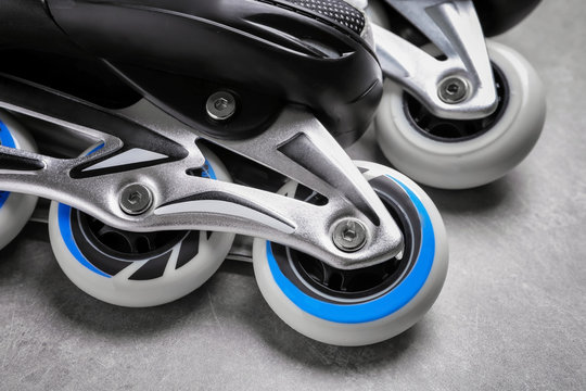 Pair of roller skates on grey background, closeup