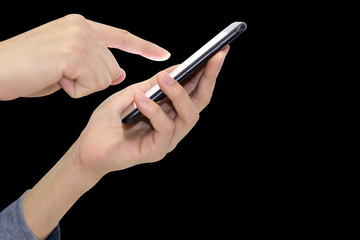 Left hand holding mobile phone isolated on black background.