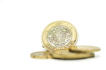 Coin pile, Mexican peso money on solid white background.
