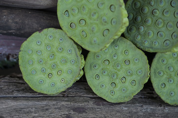 Lotus seed or lotus nut. Good for healthy and can eat both fresh and dried seed or cooking as a food. Shooting on vintage wood surface table.