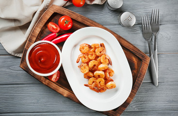 Plate with fresh tasty shrimp basket and sauce on table