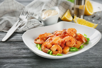 Plate with fresh tasty shrimp basket on table