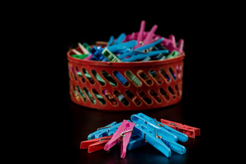 Old plastic buckles on a black countertop. Clipped very worn on a black background.