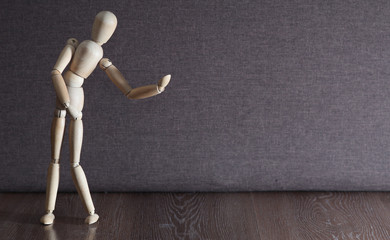 A figurine of a wooden man dreams of a partner in dance. Lonely man. Search for a partner.