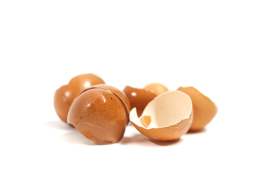 Broken eggs isolated on white background.