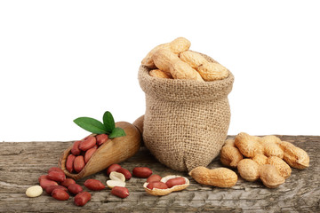 peanuts with leaf in bag on old wooden background