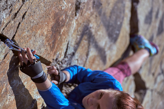 The Girl Is Climbing A Complex Rocky Terrain.