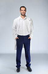 Fototapeta premium Young pharmacist on light background