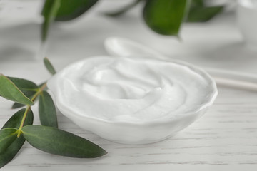 Body cream on wooden background