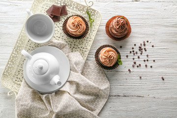 Composition with tasty chocolate cupcakes on wooden background