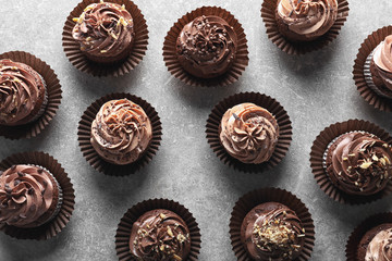 Tasty chocolate cupcakes on grey background