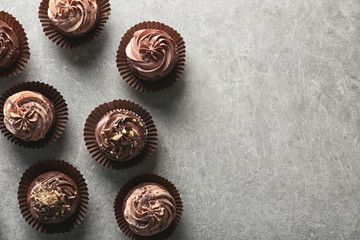 Tasty chocolate cupcakes on grey background