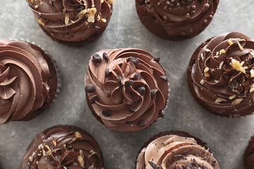 Tasty chocolate cupcakes on grey background