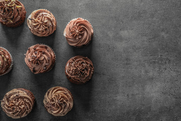 Tasty chocolate cupcakes on grey background