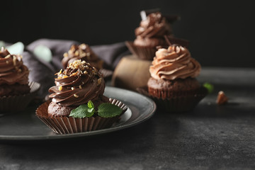 Tasty chocolate cupcake on metal tray