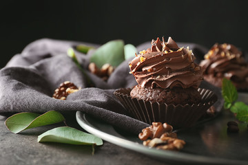 Tasty chocolate cupcake on metal tray