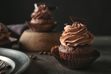 Tasty chocolate cupcake on table