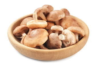 Raw shiitake mushrooms in bowl, isolated on white