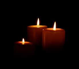 Burning candles on dark background