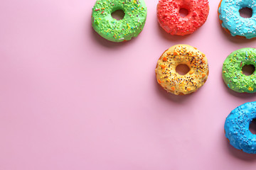 Tasty glazed donuts on color background