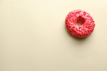 Fototapeta na wymiar Tasty glazed donut on color background
