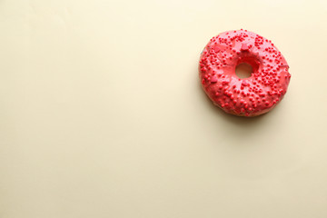 Tasty glazed donut on color background