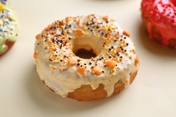 Tasty glazed donut on color background