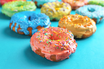 Tasty glazed donuts on color background