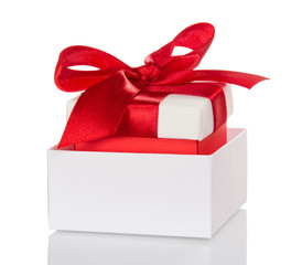 Christmas gifts, decorated with red bow in white box isolated on white