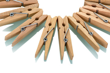 Many wooden clothespins, nicely laid out, isolated on white