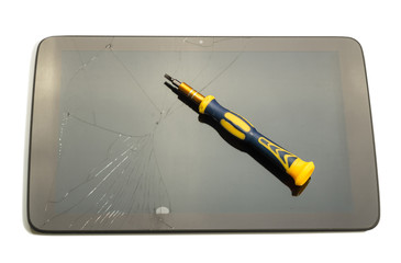 Damaged electronic device, screwdriver on top, isolated on white