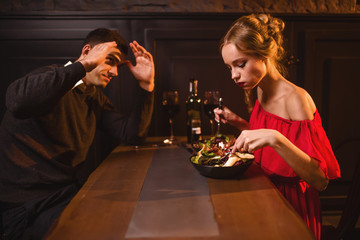 Quarrel of couple in restaurant, bad evening