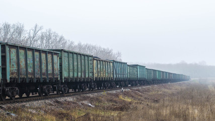 Obraz premium Freight train, railway wagons with motion blur effect. Transportation, railroad