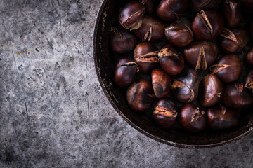 Roasted chestnuts on an old board. healthy food concept