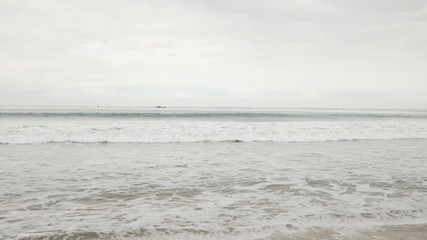 small waves on Santa Monica beach in cloudy november day